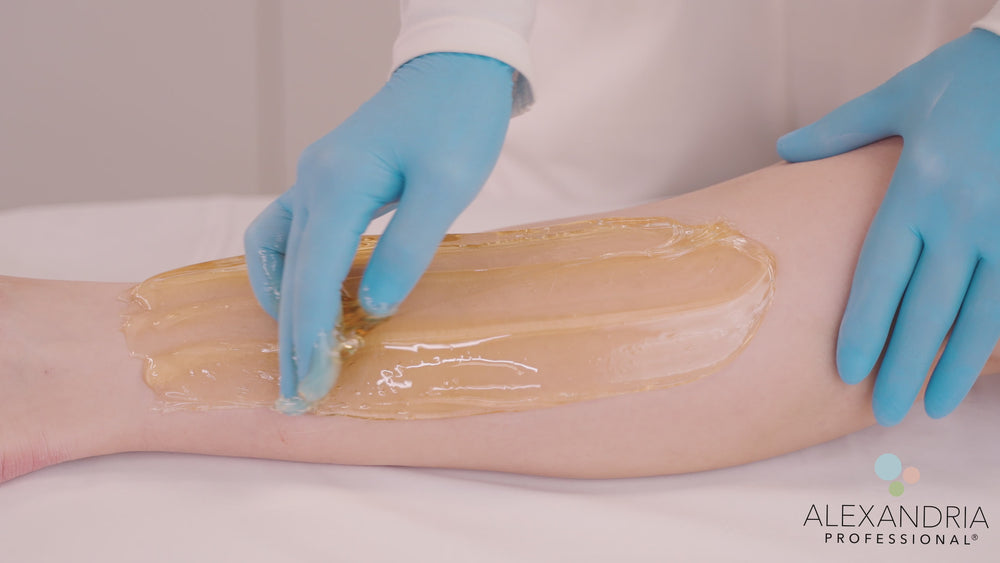 Professional applying Alexandria Professional sugaring paste to a client